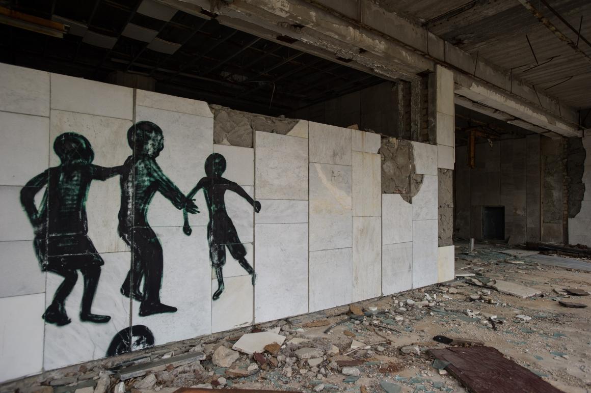 Graffiti artists have drawn strange shadowy figures on the walls of buildings.